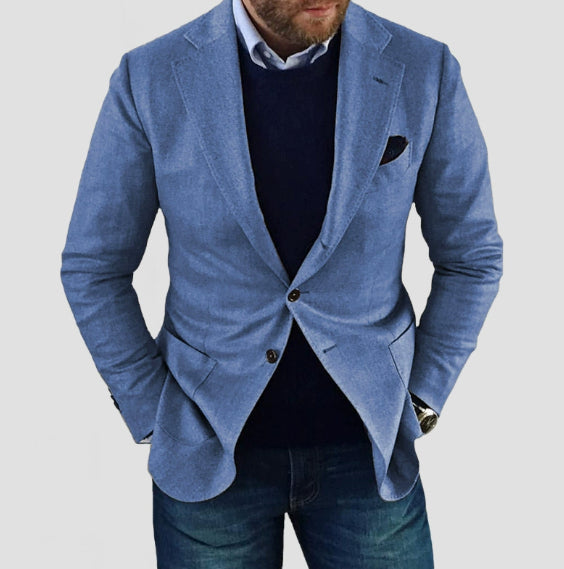 Blue blazer over a dark shirt and jeans on a light gray background
