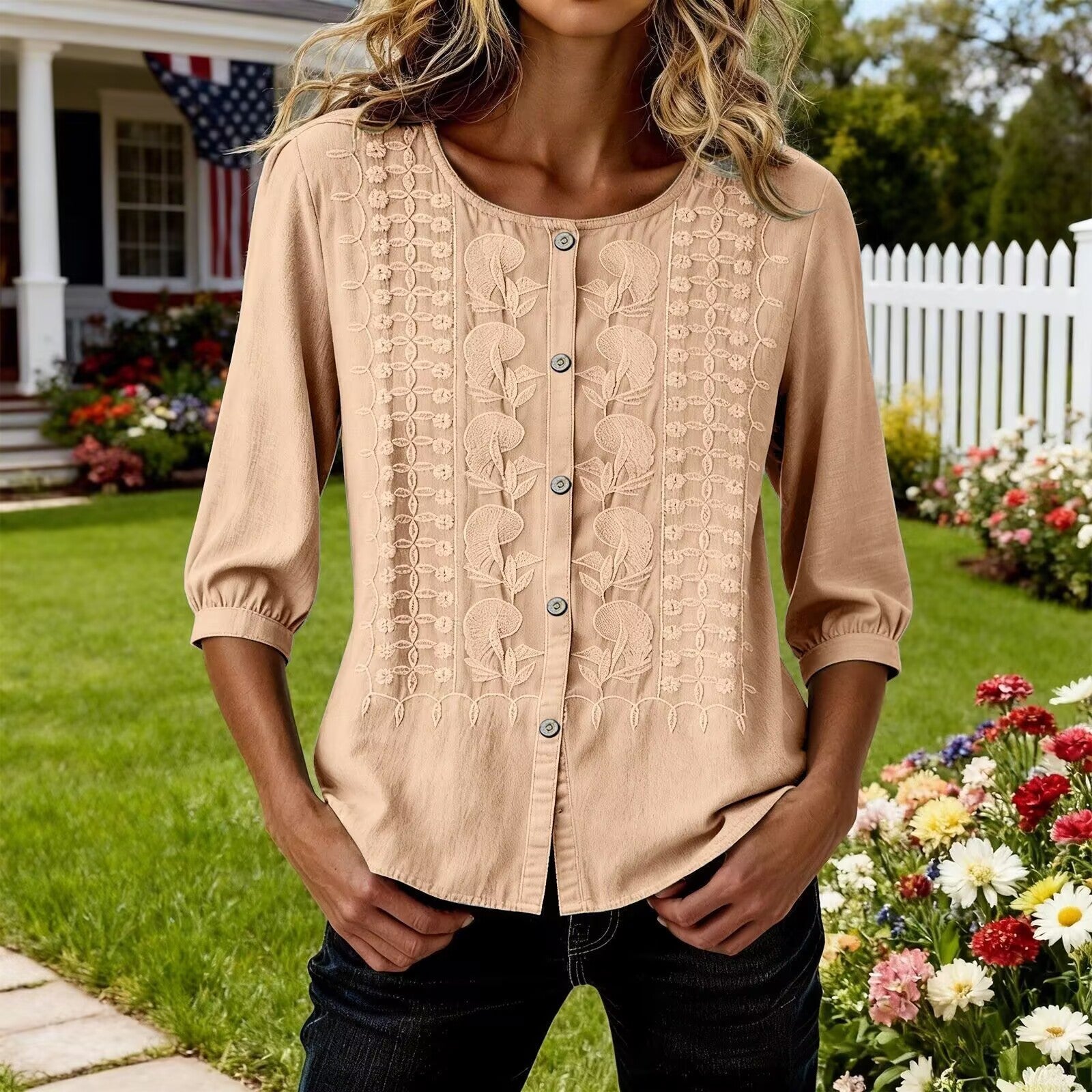 Woman wearing a beige blouse with floral patterns in a garden setting