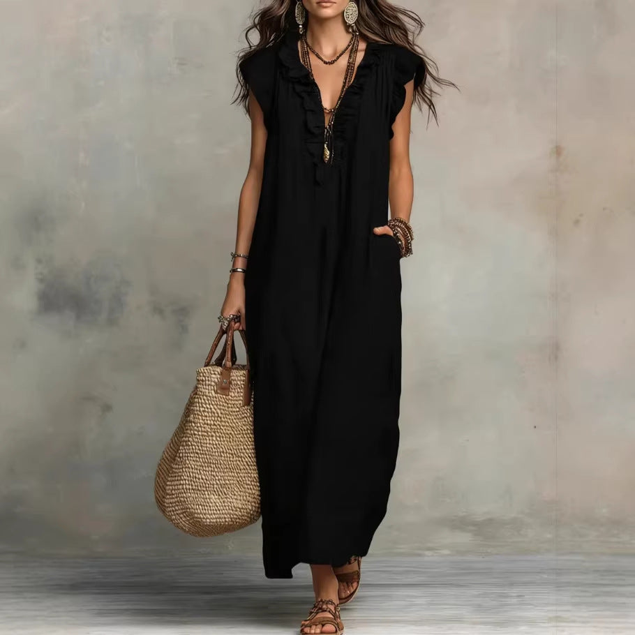 Woman wearing a black sleeveless dress holding a woven bag against a neutral background