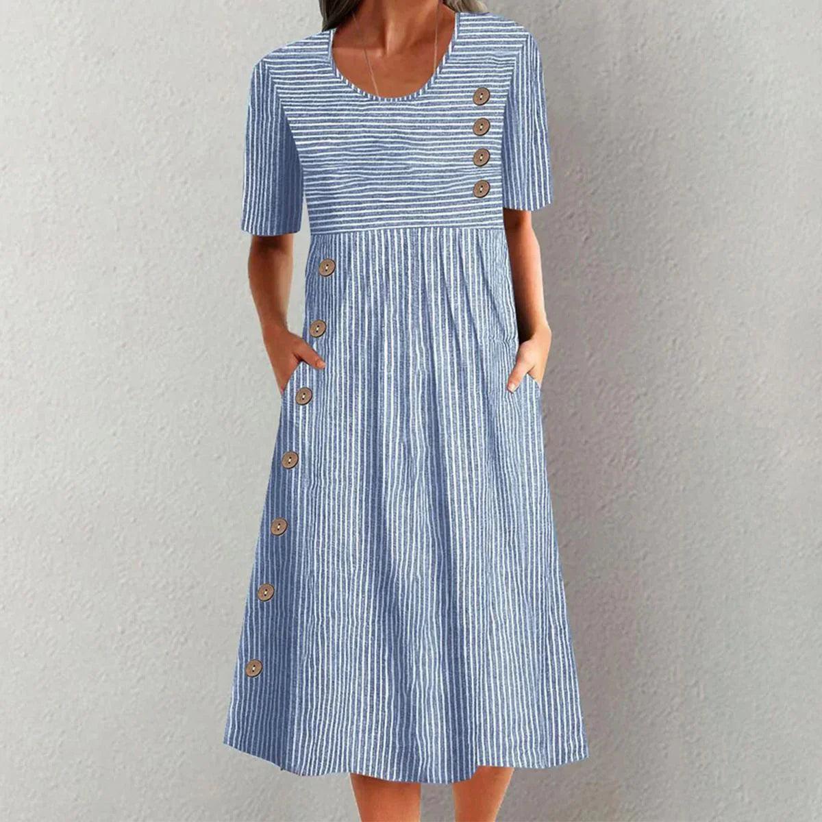 Blue and white striped dress with button details on a gray background