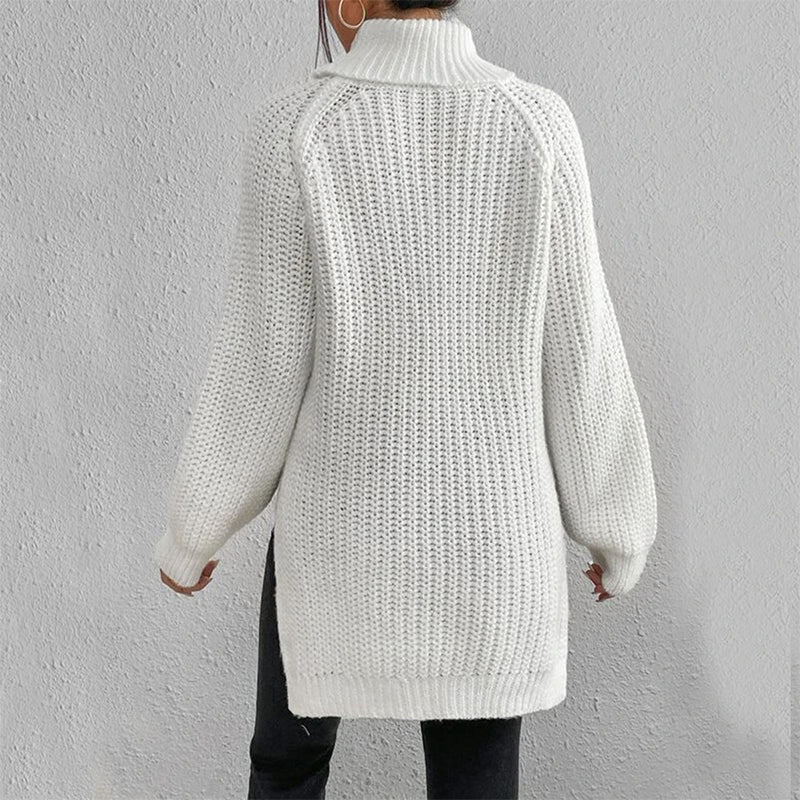 White knitted cardigan worn by a person on a plain background