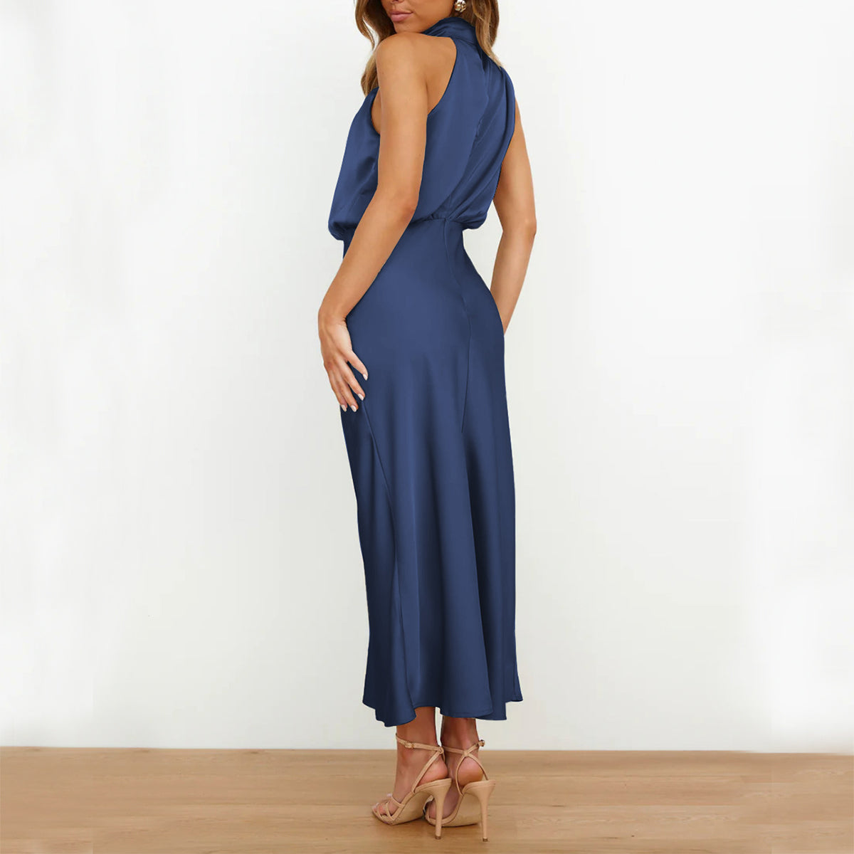 Woman wearing a blue jumpsuit against a white background