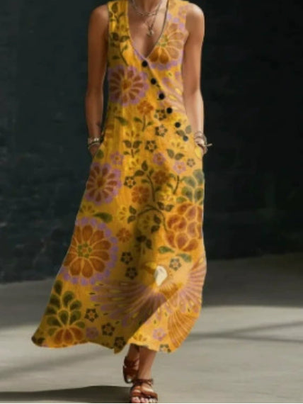 Person wearing a yellow floral dress on a dark background