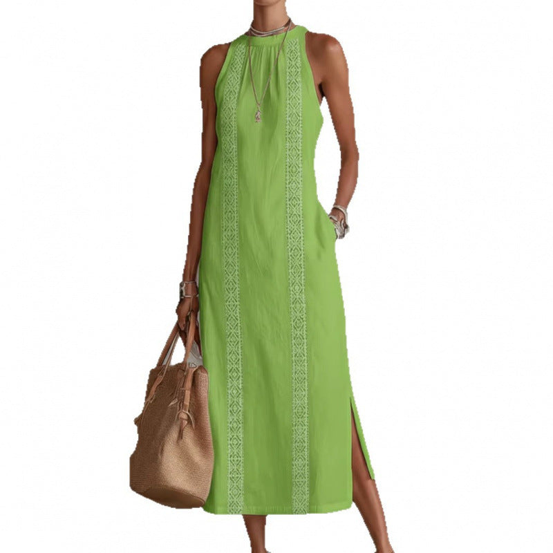 Green sleeveless dress with embroidery and a brown handbag on a white background