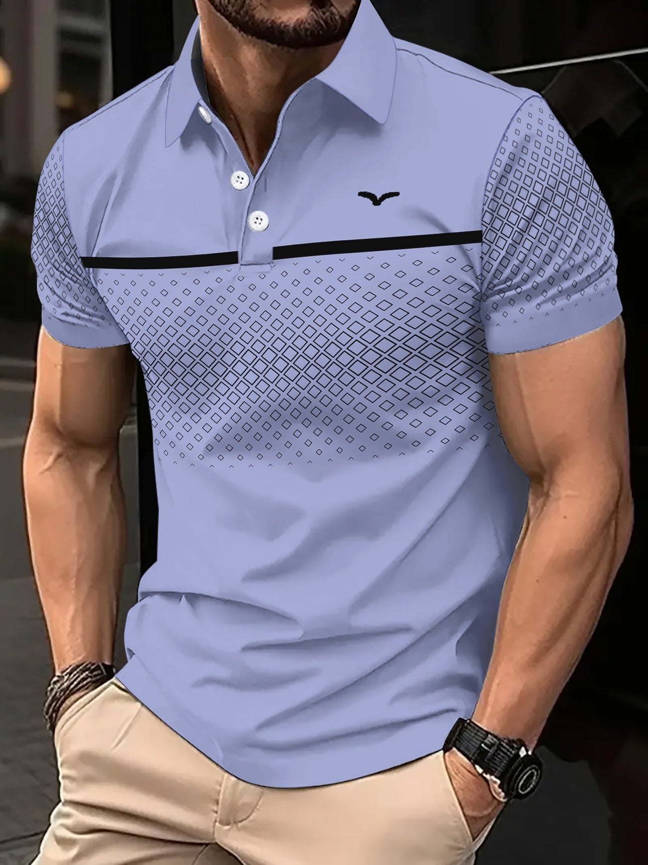 Man wearing a light blue polo shirt with a geometric pattern, standing against a blurred background.