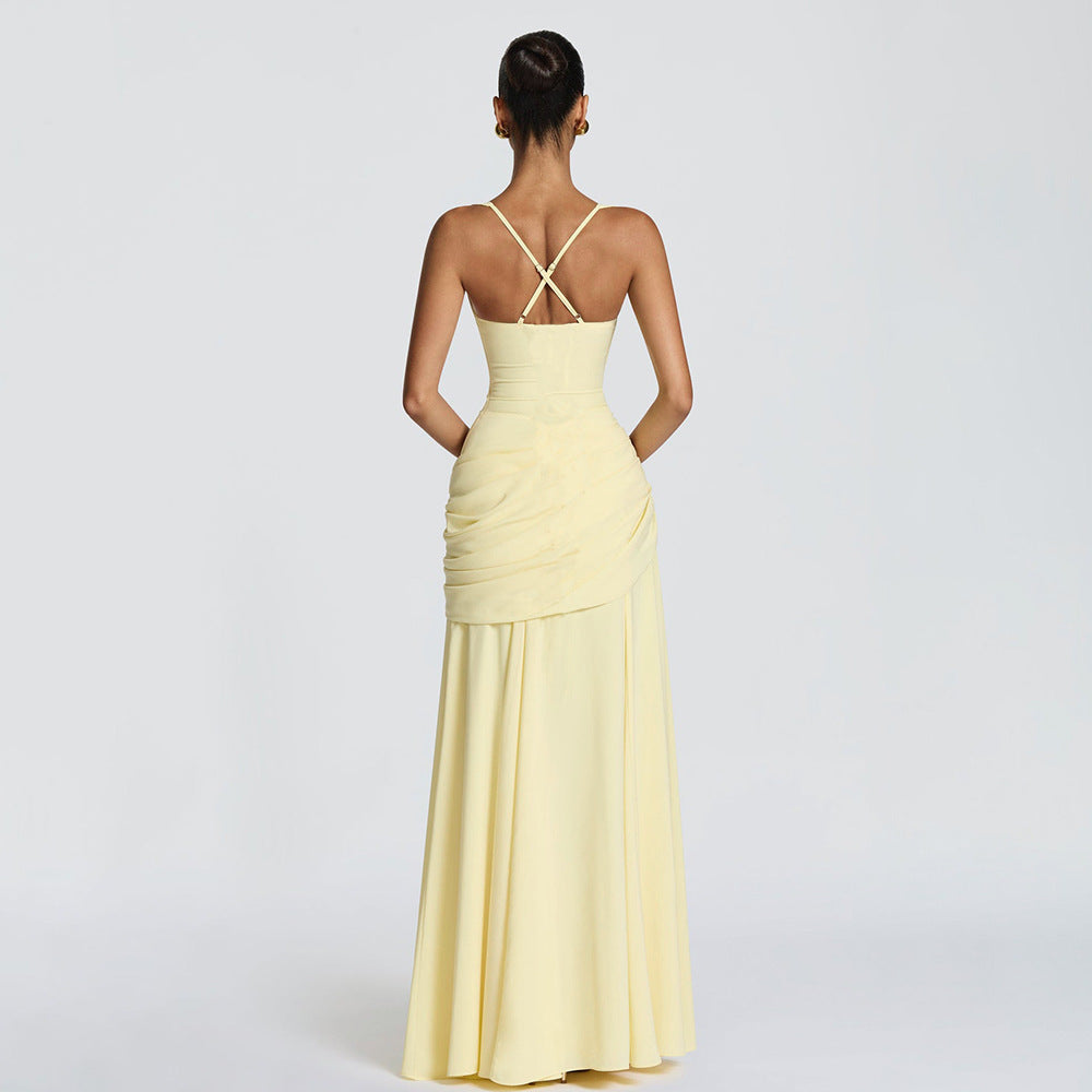 Yellow evening gown with a backless design on a white background