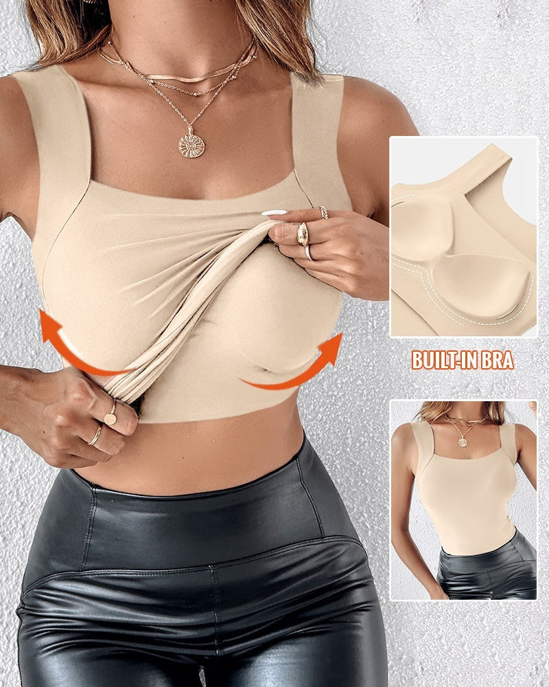Woman wearing a beige top with built-in bra feature, shown on a textured white background.