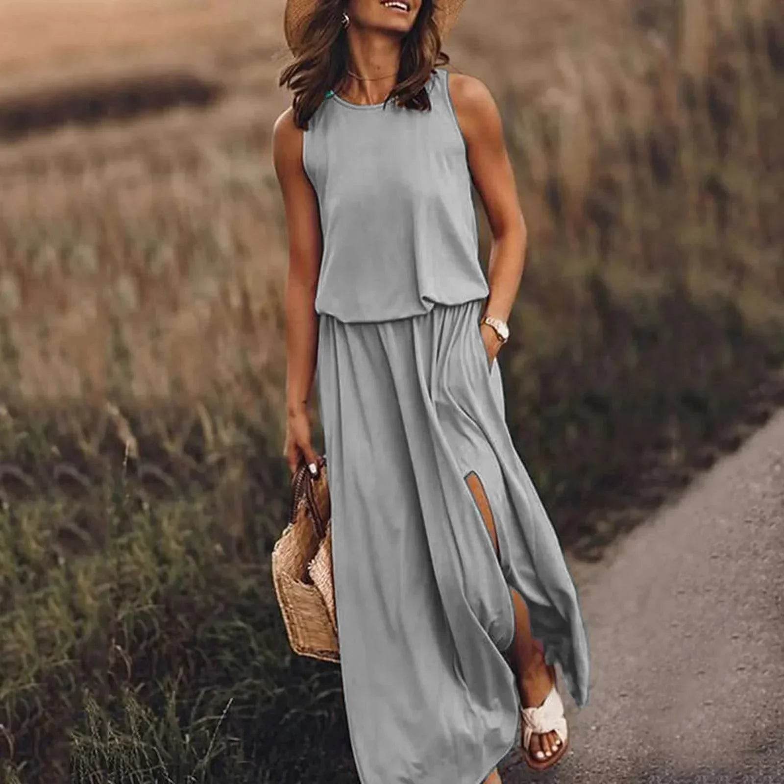 Woman in grey sleeveless maxi dress and straw hat walking outdoors, ZA-Zola fashion style