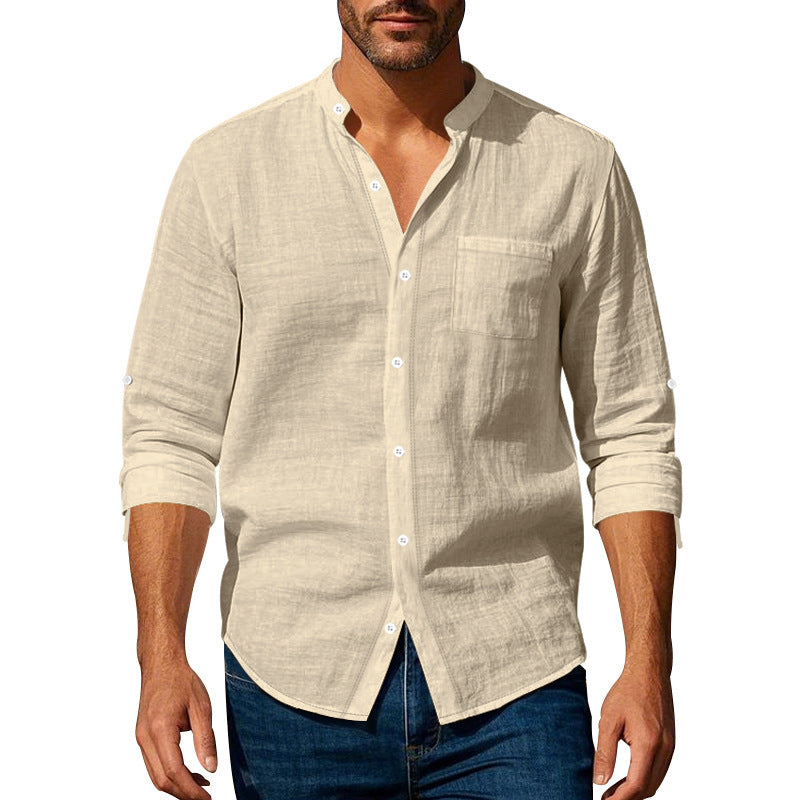 Man wearing a beige button-up shirt with rolled-up sleeves on a white background