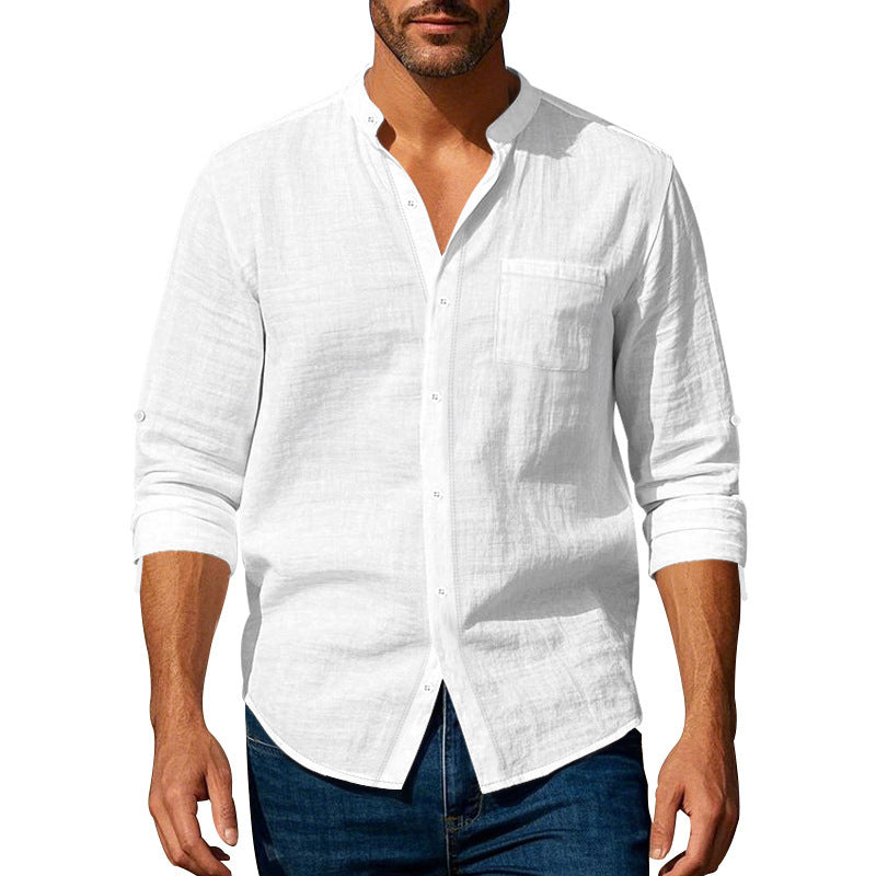Man wearing a white linen shirt with rolled-up sleeves on a white background