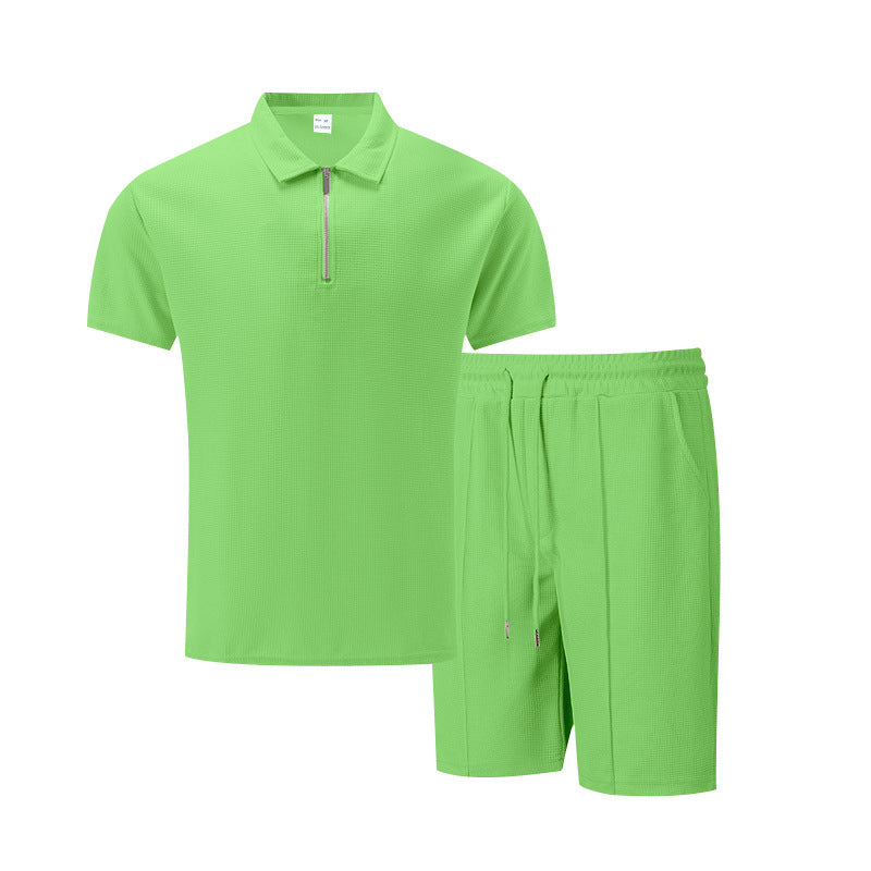 Green polo shirt and shorts set on a white background