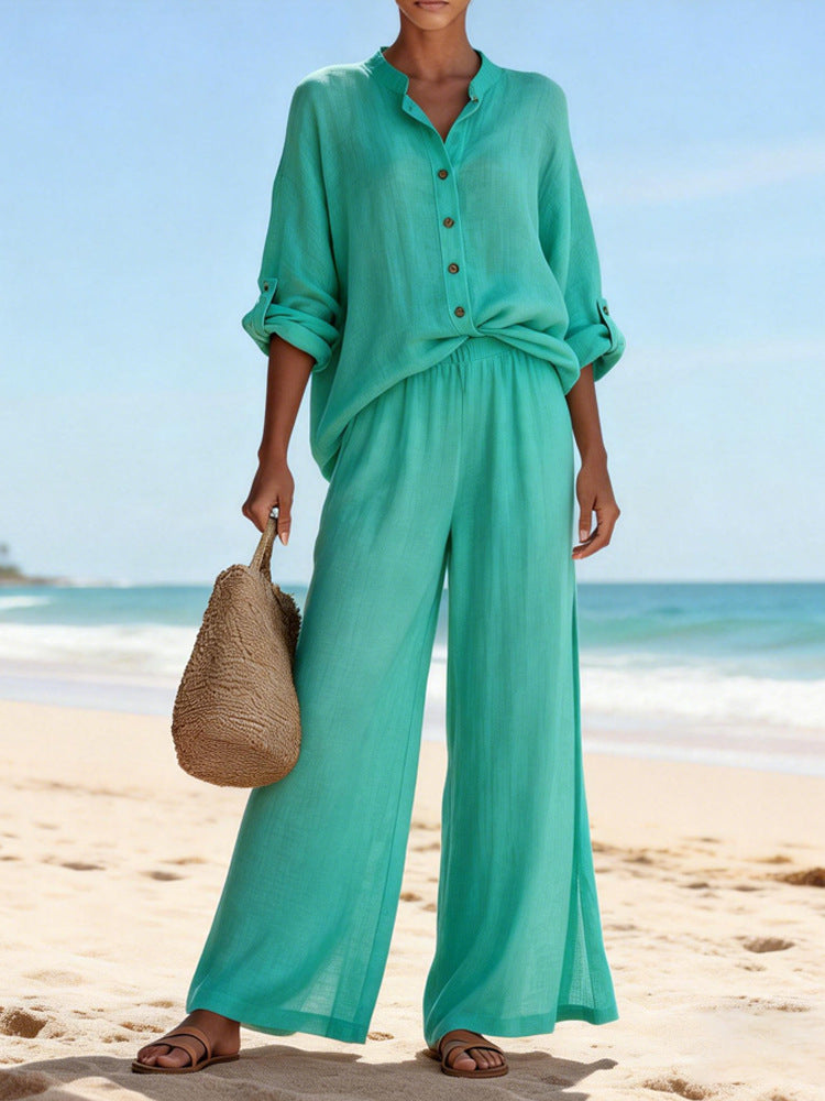 Person wearing a teal outfit on a beach