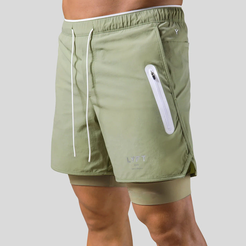 Green athletic shorts with a white zipper pocket on a gray background