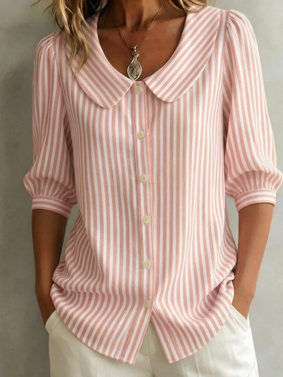 Pink and white striped shirt worn by a person on a neutral background