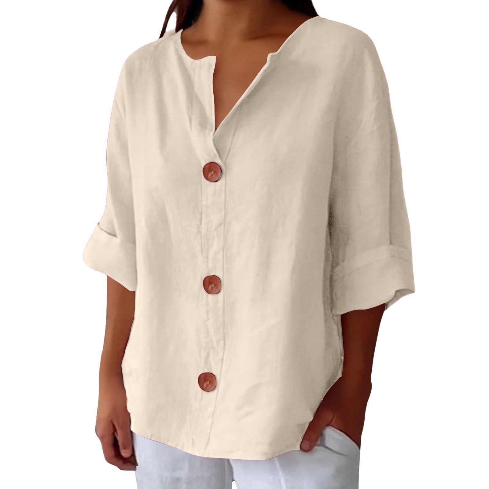Beige button-up shirt worn by a person on a white background