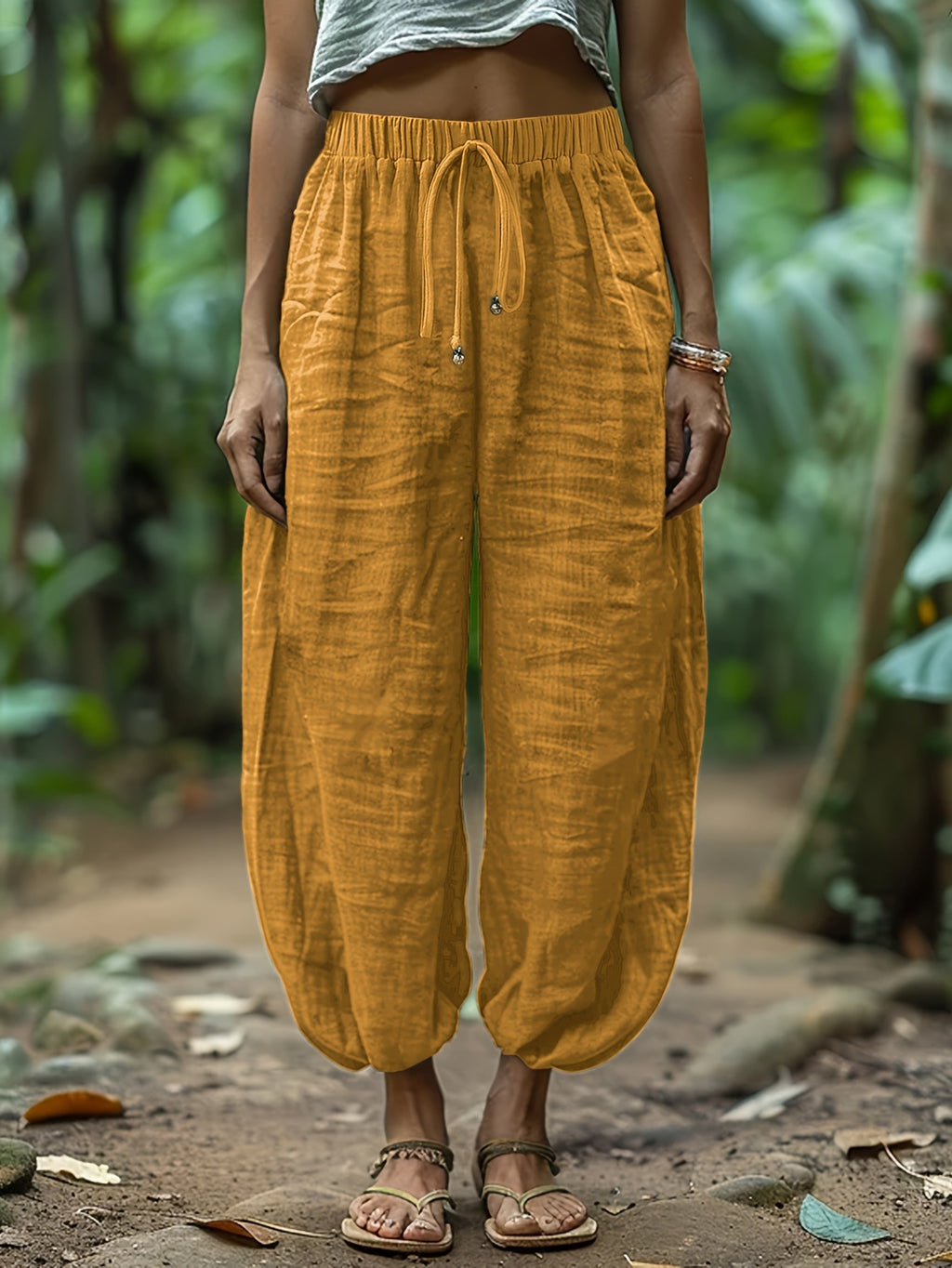 Person wearing mustard yellow pants with a blurred natural background