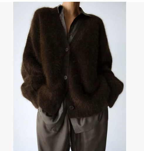 Brown cardigan worn by a person on a plain background