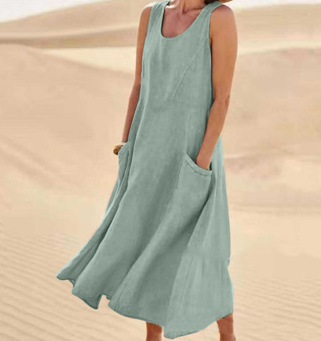 Person wearing a light green sleeveless dress against a desert background