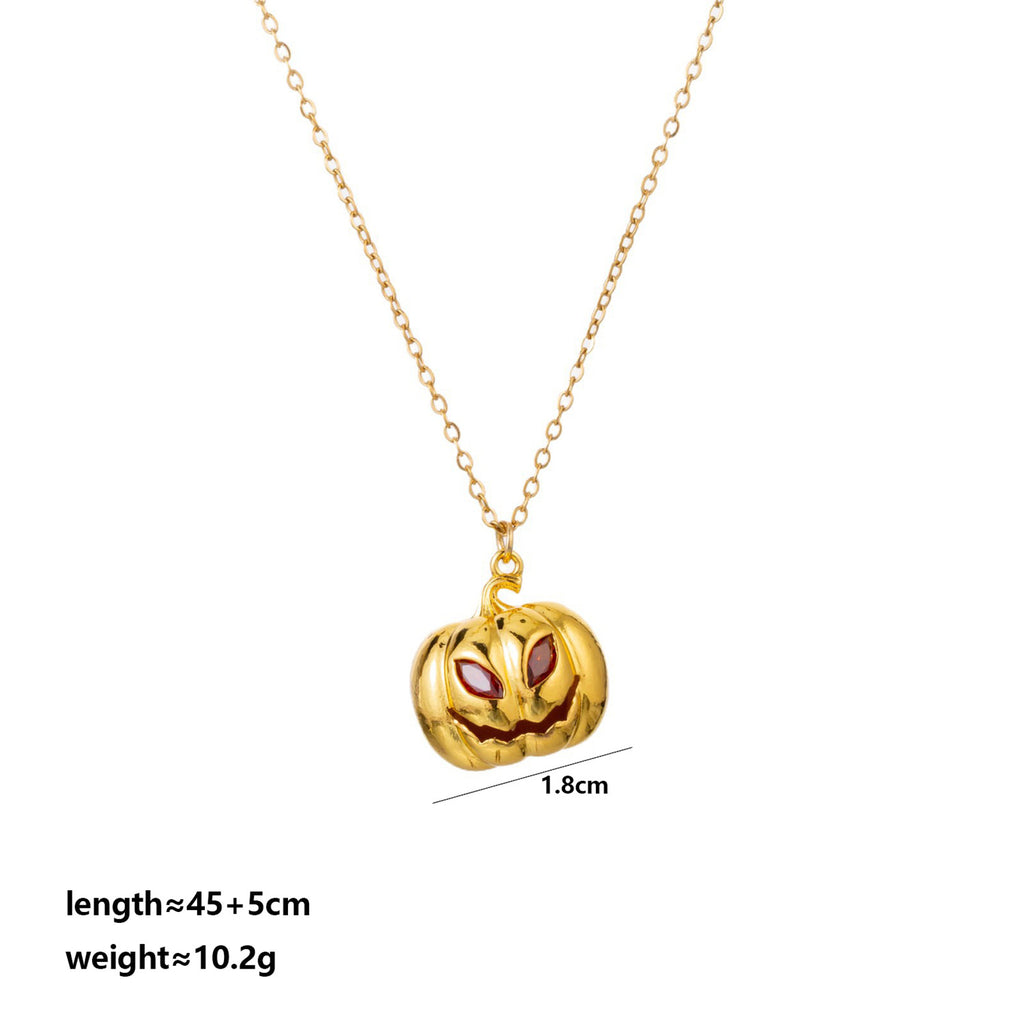 Gold pumpkin necklace with red eyes on a white background