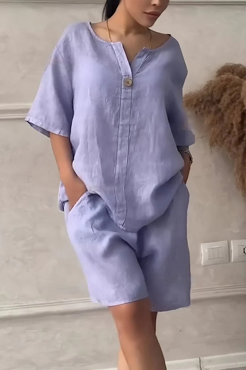 Person wearing a light blue outfit with a plain background