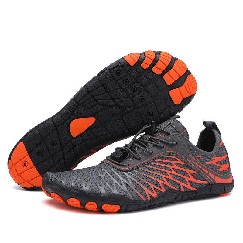Gray and orange athletic shoes on a white background