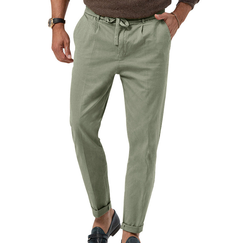 Green pants worn by a person on a white background
