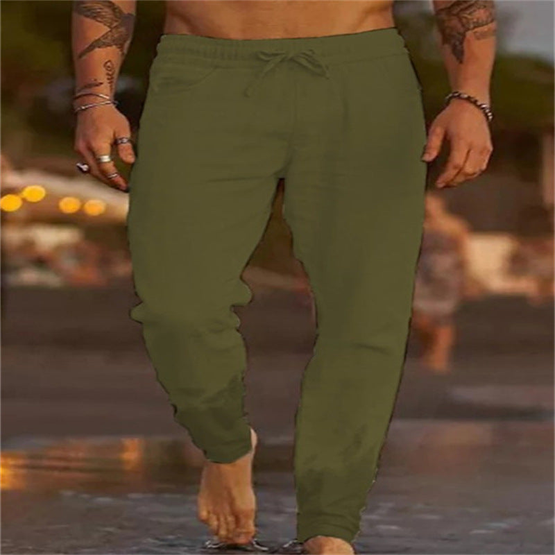 Person wearing green jogger pants with a blurred background