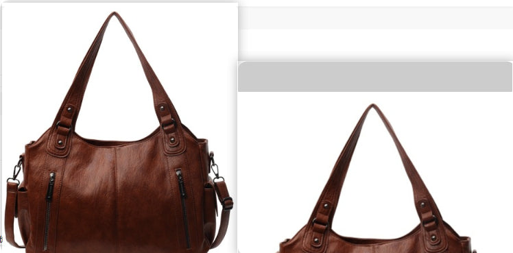 Brown handbag with visible zippers on a white background