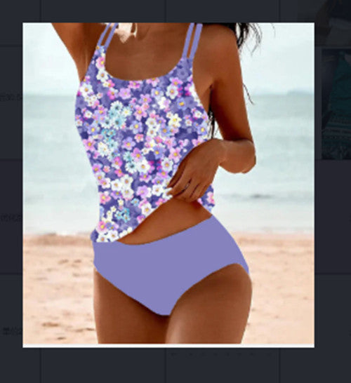 Person wearing a floral purple swimsuit on a beach