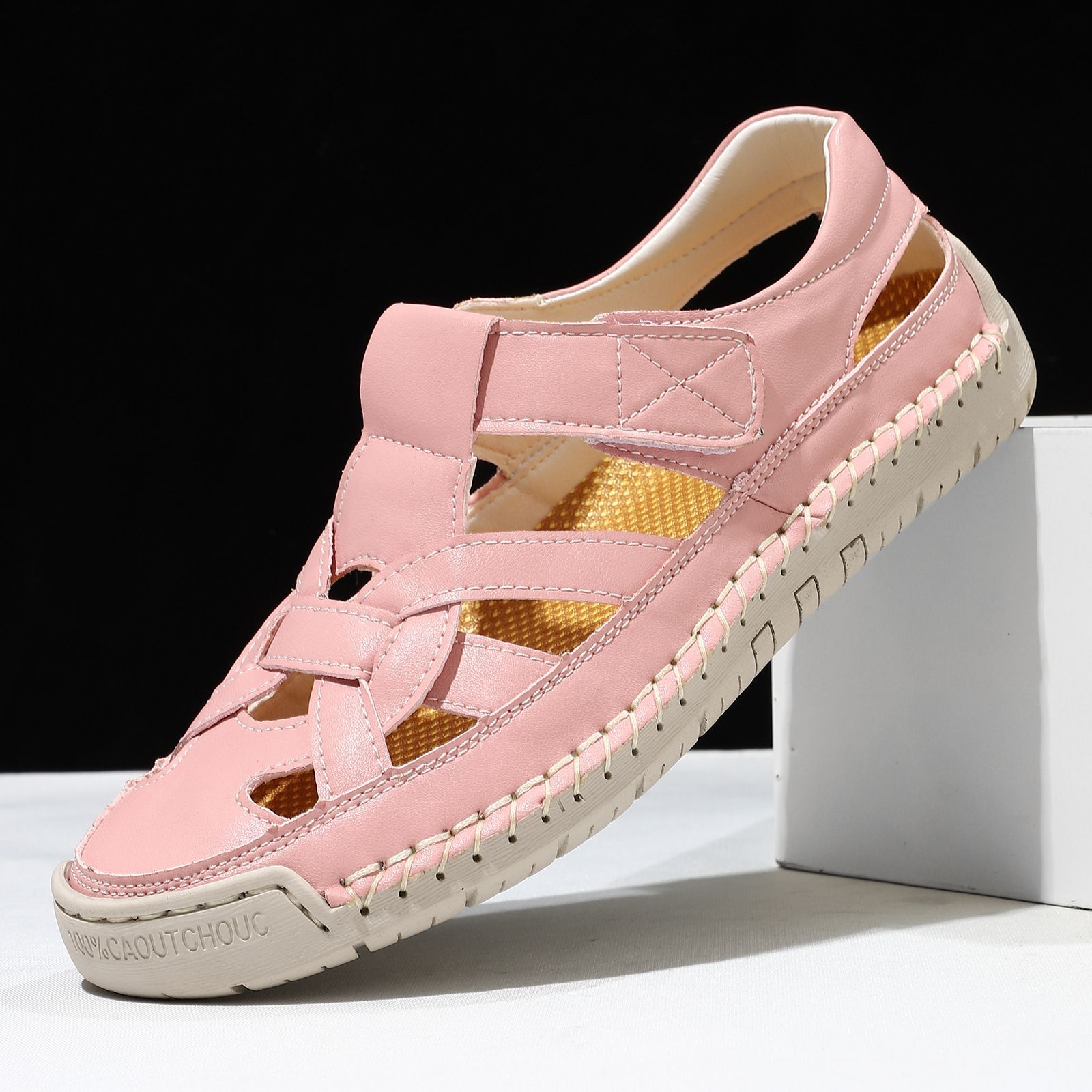 Pink sandal with a white sole on a black background