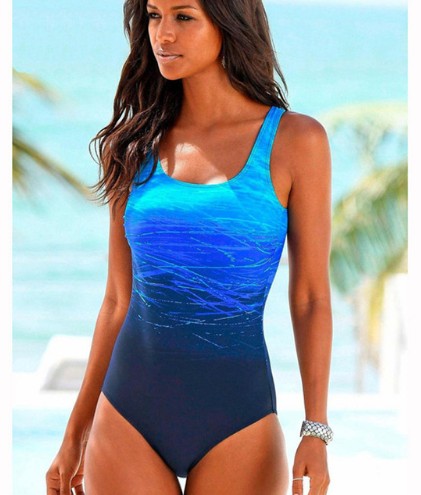 Woman wearing a blue swimsuit with a beach background