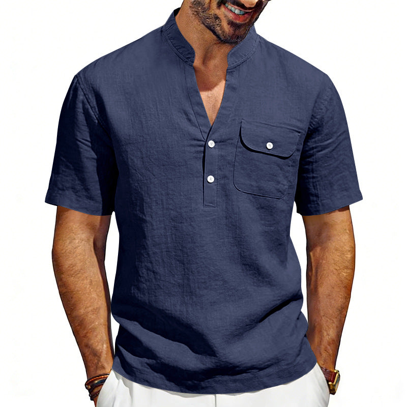 Man wearing a navy blue short-sleeve shirt with a pocket on a white background