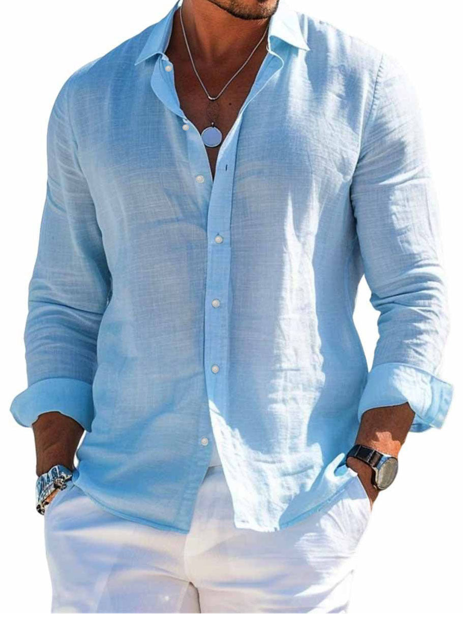 Man wearing a light blue button-up shirt and white pants on a white background