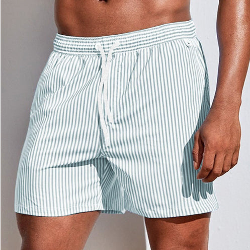 Light blue striped boxer shorts worn by a person on a plain background