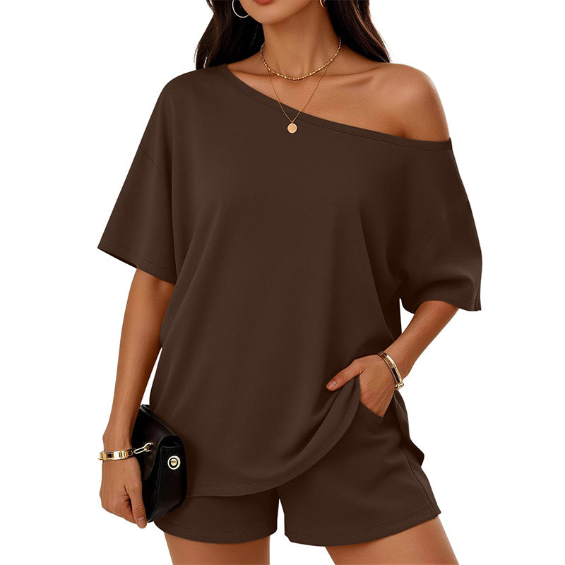 Woman wearing a brown off-shoulder top and shorts set on a white background