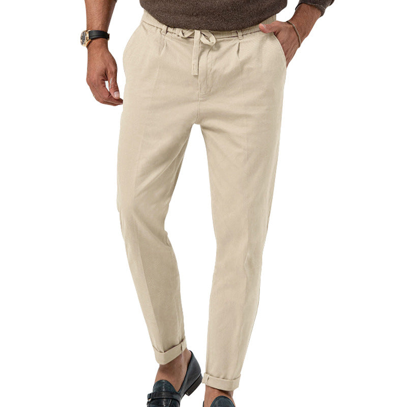 Beige pants worn by a person on a white background