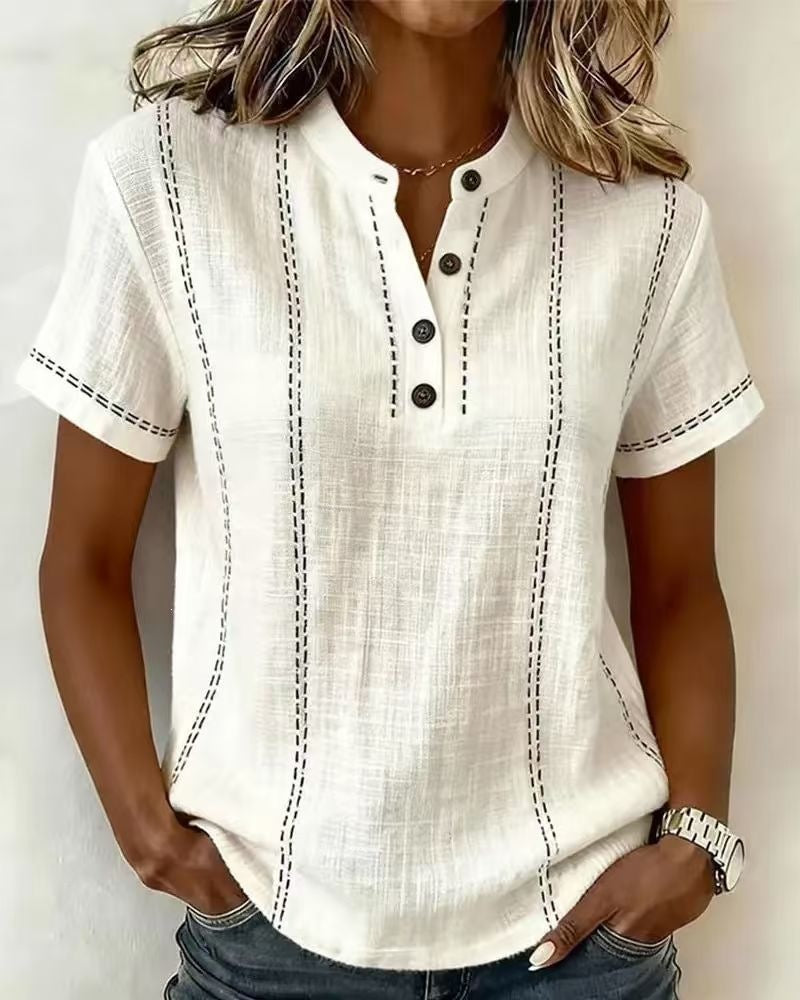 White short-sleeve shirt with black buttons and stitching on a plain background