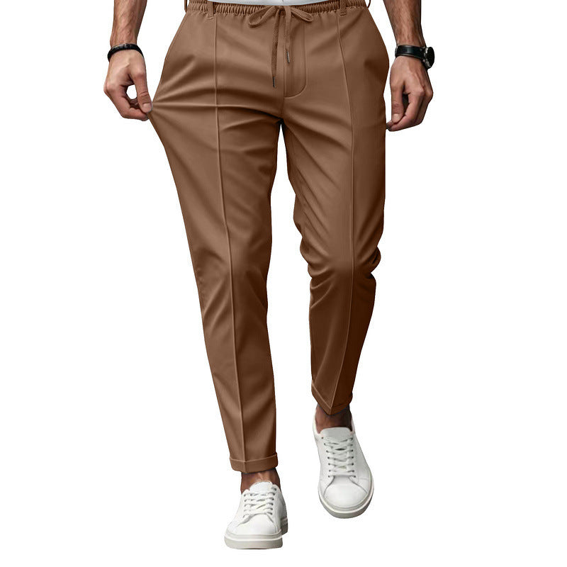 Brown pants worn by a person on a white background
