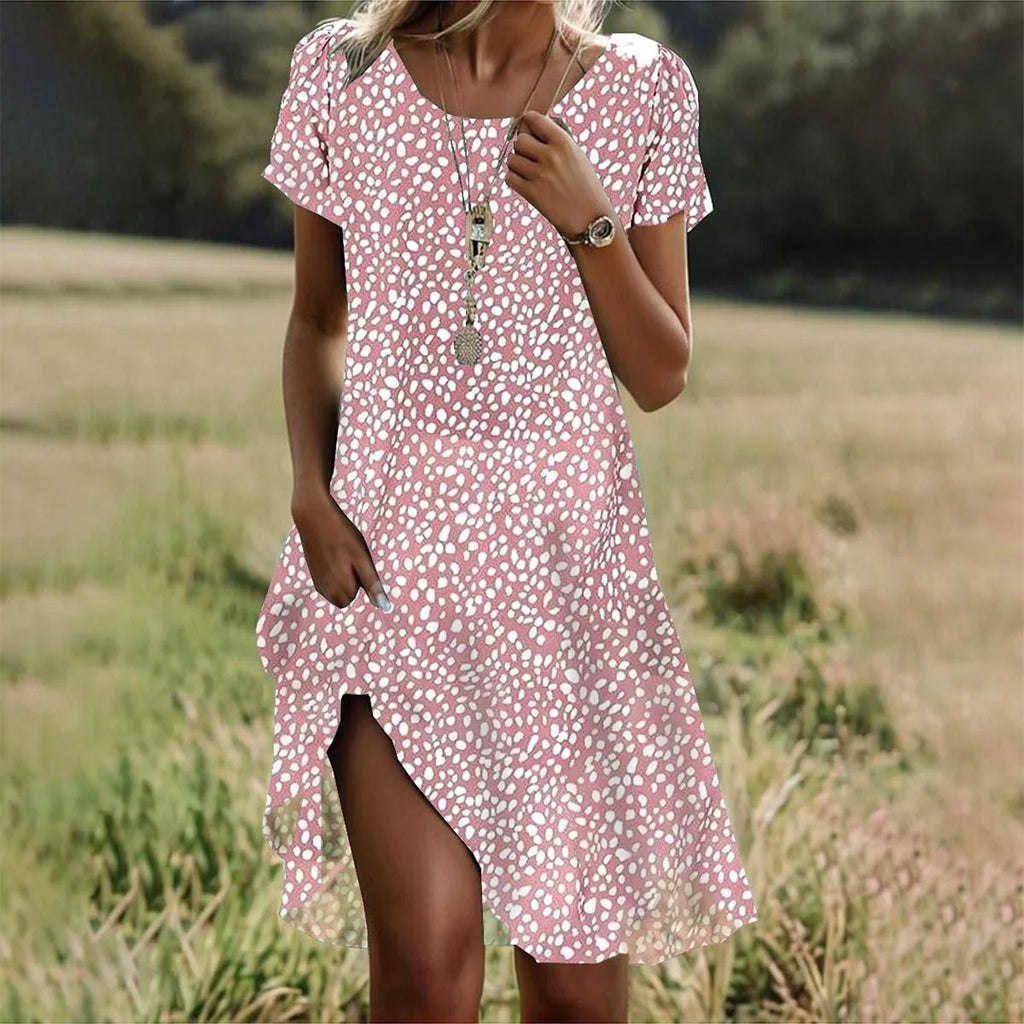 Woman wearing a pink floral dress in a field