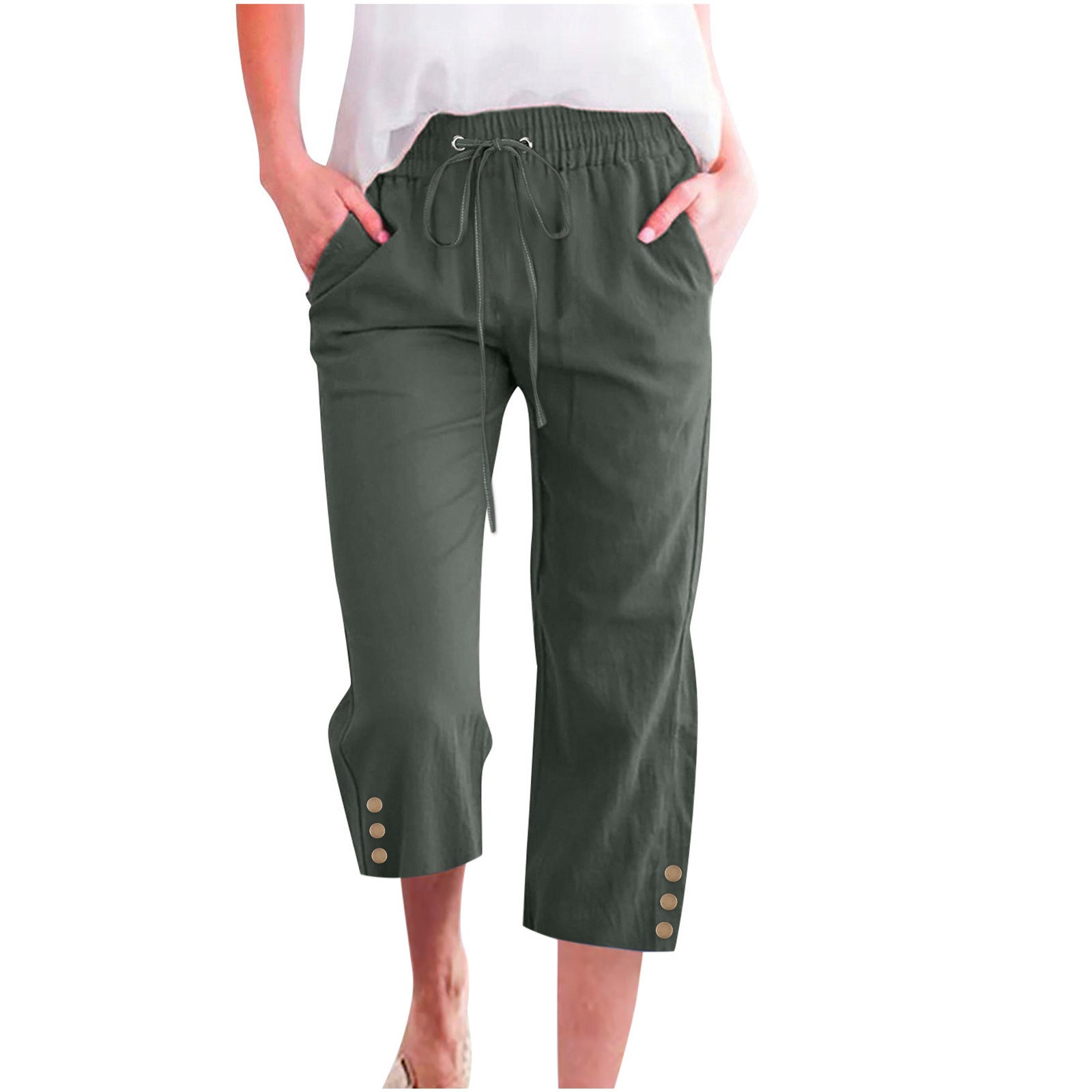 Green capri pants worn by a person on a white background