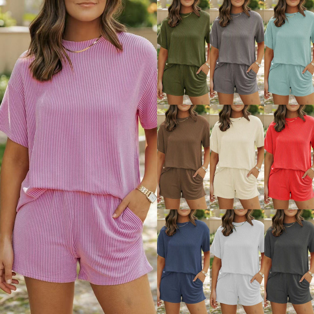Woman wearing a pink ribbed lounge set with multiple color options displayed.