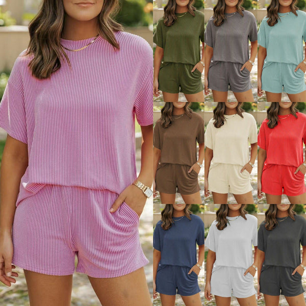 Woman wearing a pink ribbed lounge set with multiple color options displayed.