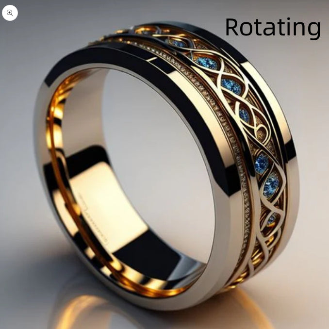 Gold ring with intricate design and blue gemstones on a reflective surface