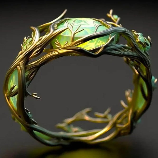 Elaborate ring with green gem and gold vine design on a dark background