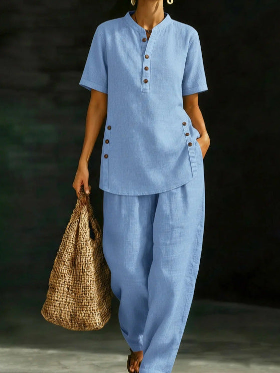 Person wearing a blue outfit holding a woven bag against a dark background