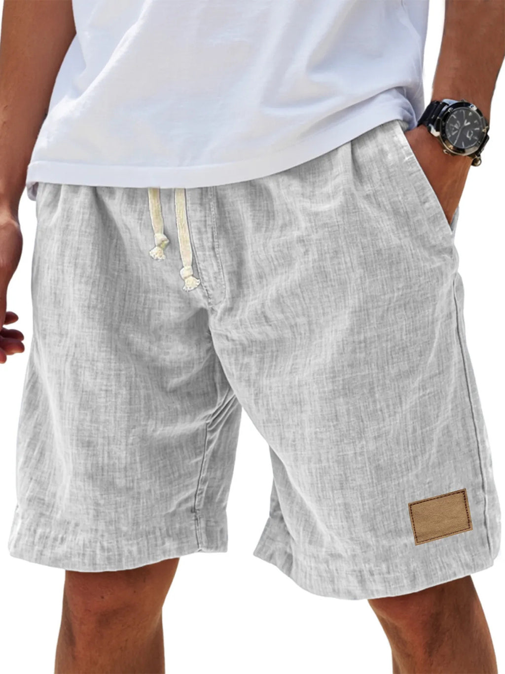 Light gray shorts with a drawstring and patch on a white background