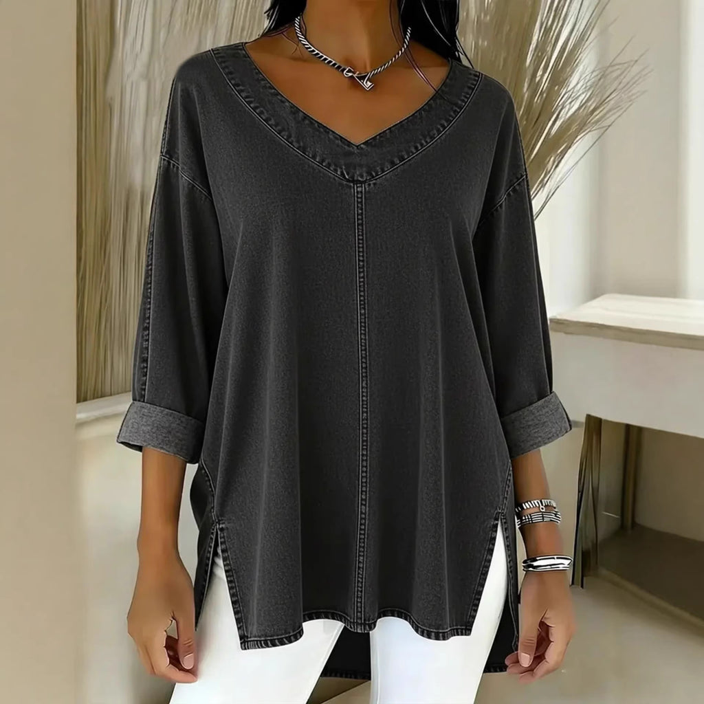 Black denim shirt worn by a person with a neutral background