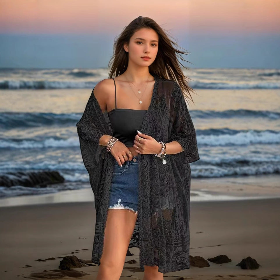 Woman standing on a beach with ocean waves in the background