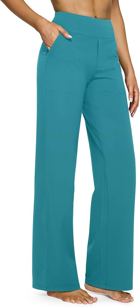 Teal pants worn by a person on a plain background