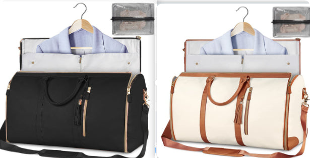 Black and white travel bags with clothes on hangers on a white background